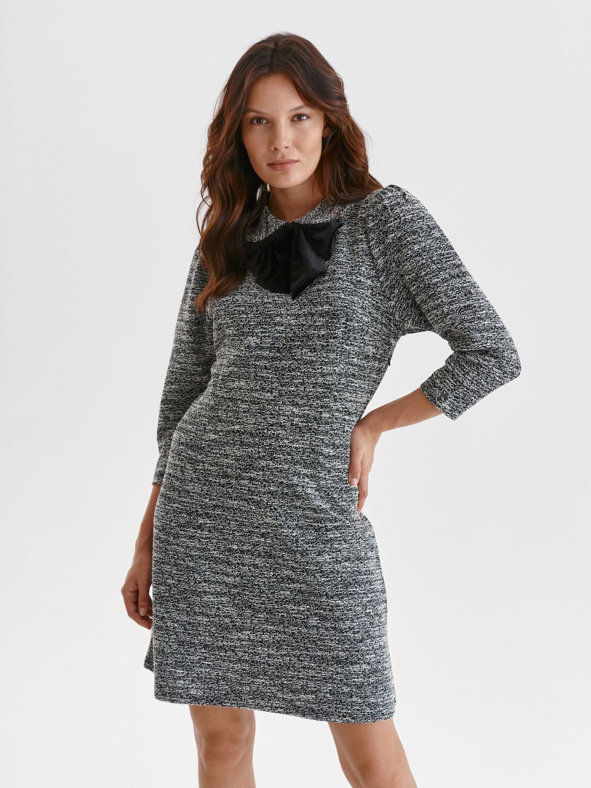 Grey dress knitted short cut a-line accessorized with breastpin