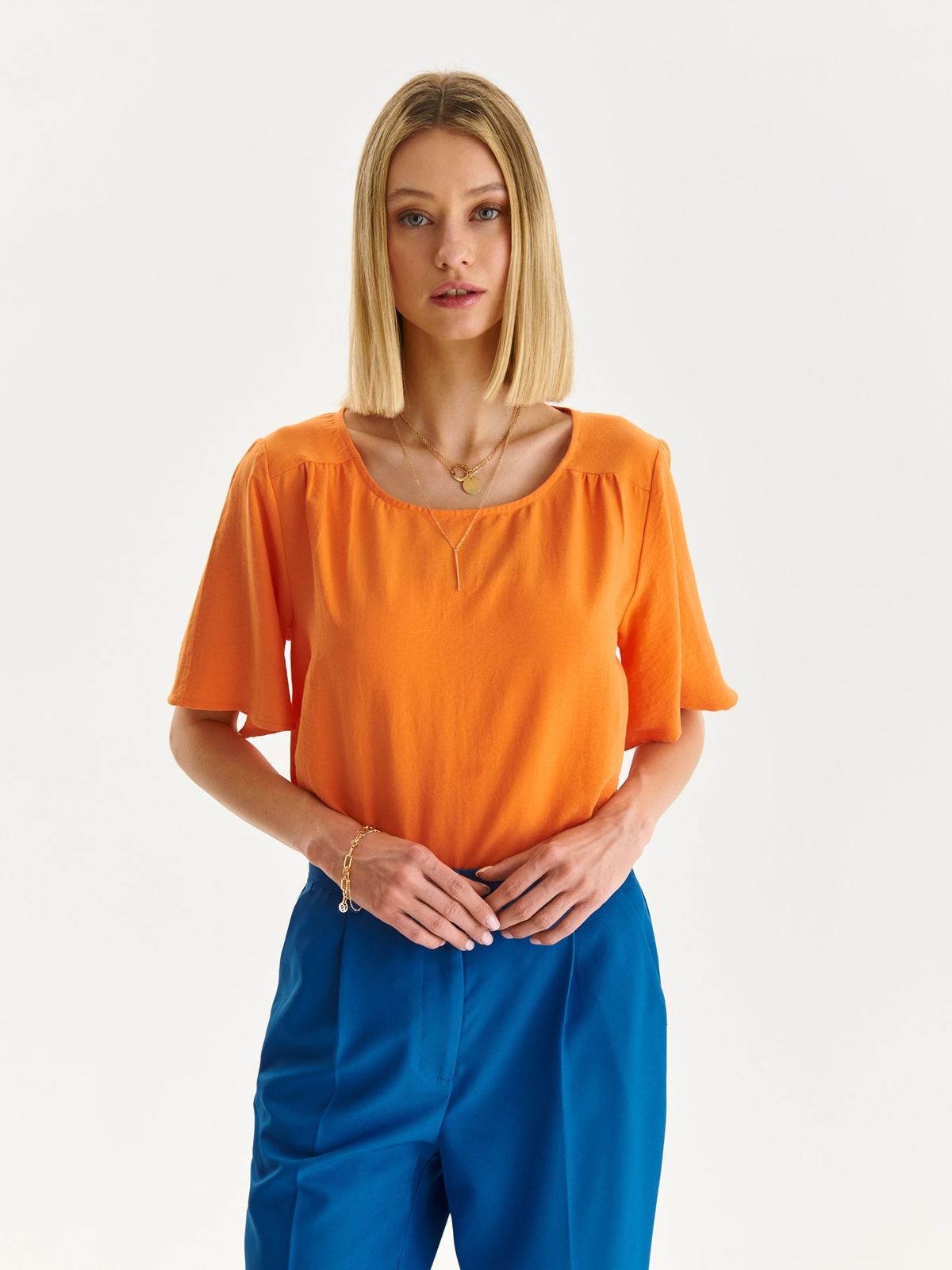 Orange women`s blouse thin fabric loose fit with rounded cleavage