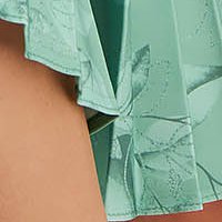 Pleated dress made of slightly elastic light green fabric in flared style with belt-type accessory