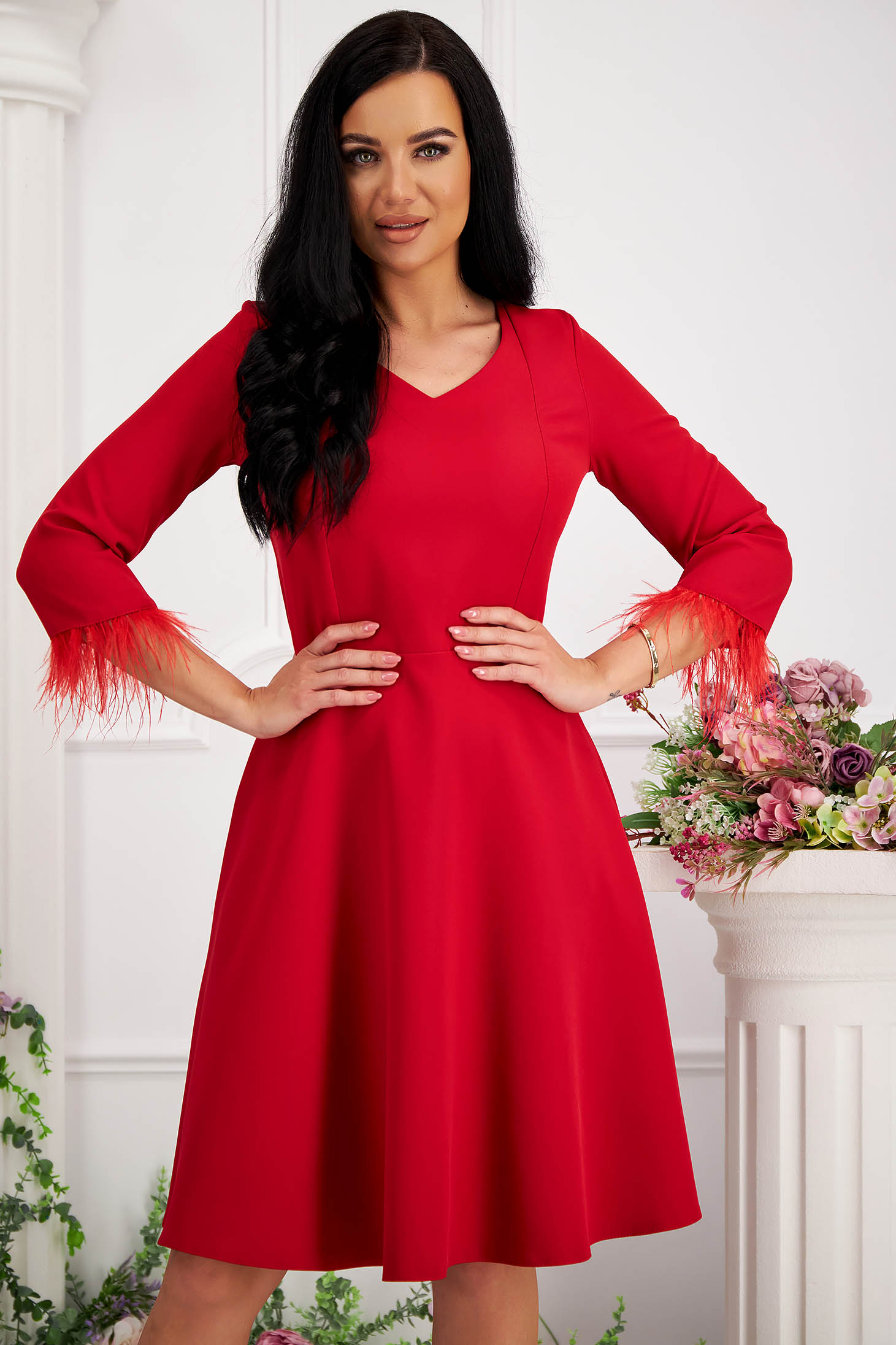 Red midi skater dress made of elastic fabric with side pockets and feathers