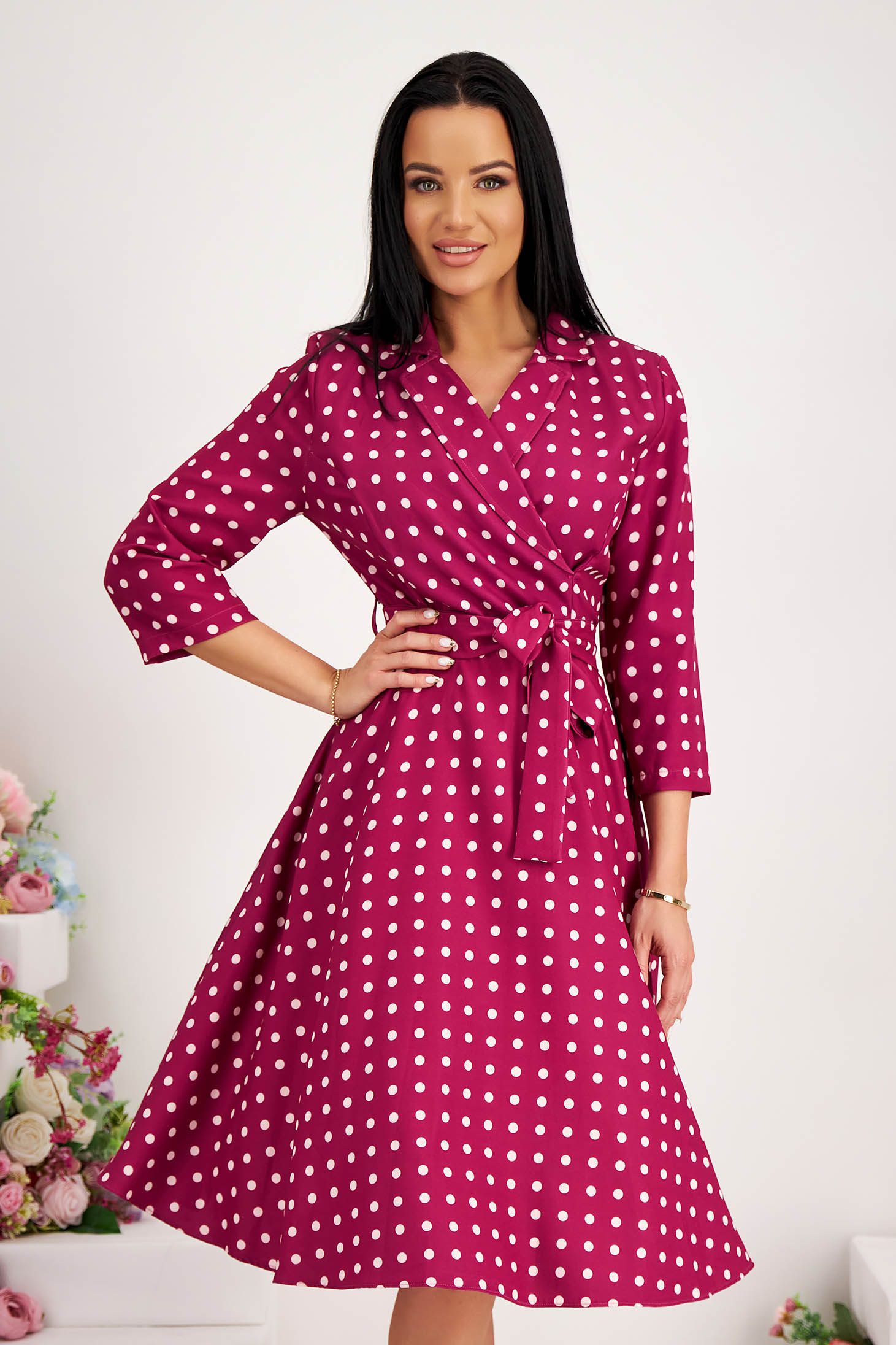 Midi dress made of stretchy fabric with a flared design, side pockets, and crossover neckline