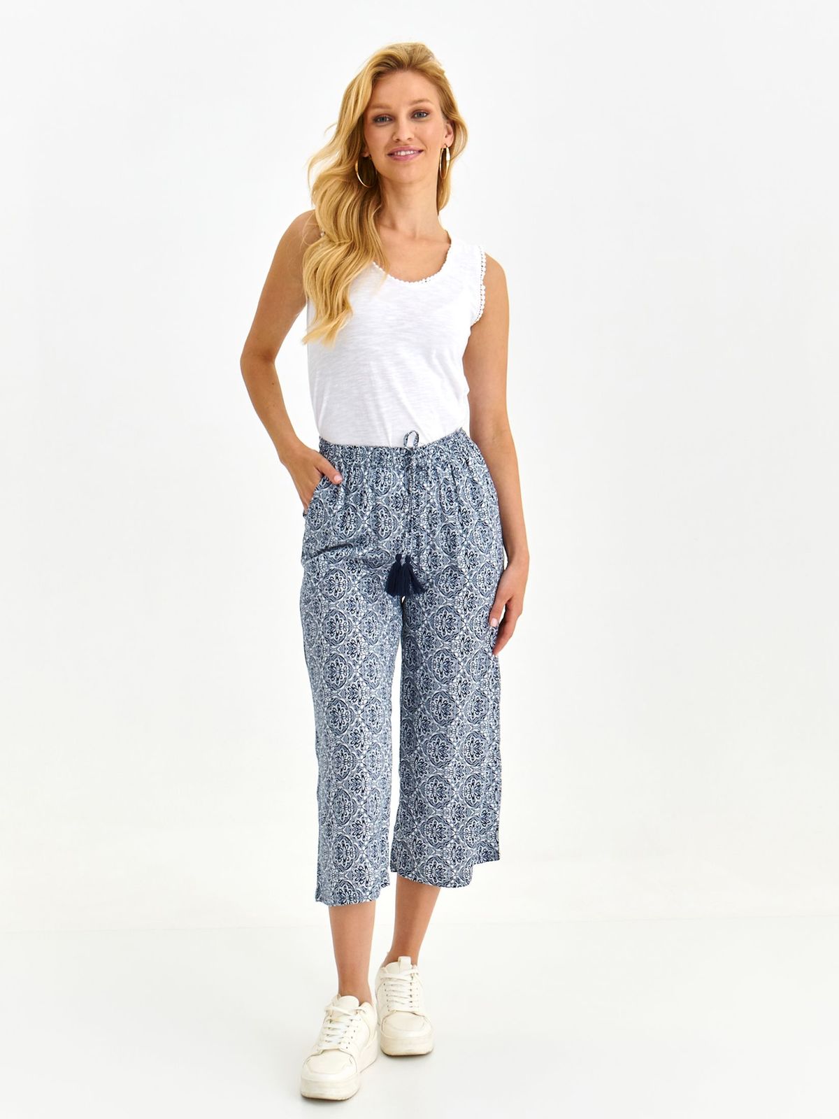 Blue trousers light material flared lateral pockets is fastened around the waist with a ribbon