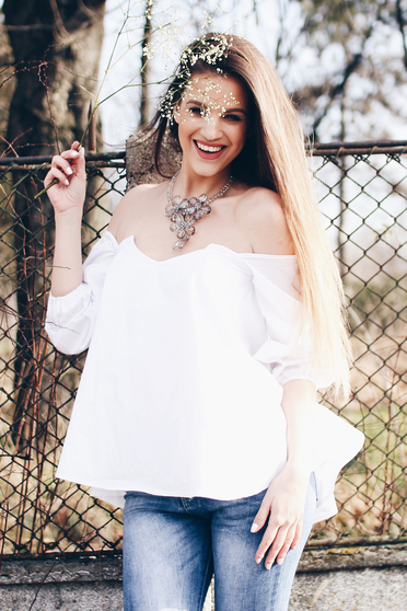 Ocassion white women`s blouse with easy cut on the shoulders