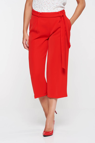 PrettyGirl red high waisted flaring cut trousers accessorized with tied waistband