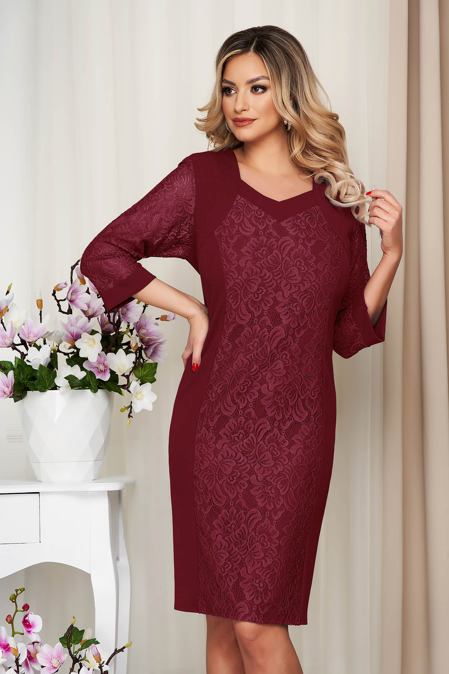 Burgundy lace dress with a tie adorning the waist