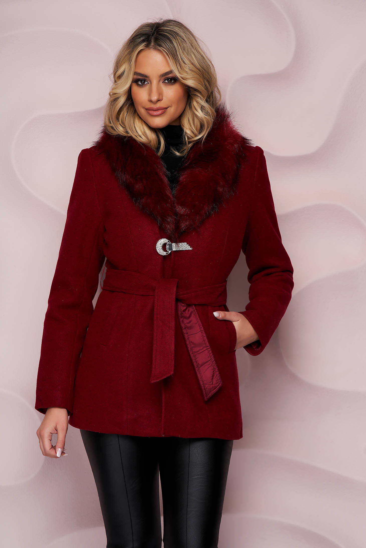 Burgundy coat tented accessorized with breastpin from wool